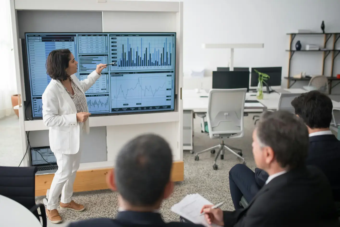 woman presenting AI software to group